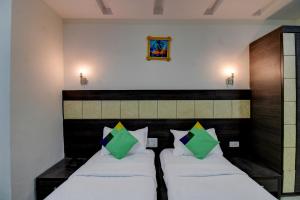 two beds in a room with two pillows at Treebo Trend Seven Suites in Nagpur
