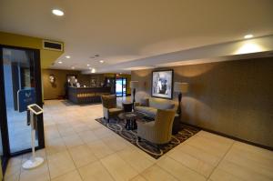a lobby of a hotel with chairs and a table at The Pacific Inn in Prince Rupert