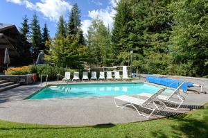 a swimming pool with lounge chairs and a swimming pool at Horstman House by Whistler Premier in Whistler