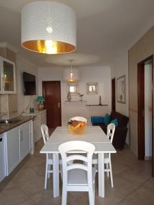 a kitchen and dining room with a table and chairs at Orlanda Veríssimo in Nazaré