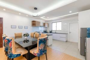 a kitchen with a dining room table and chairs at Home Sweet Home in Nairobi