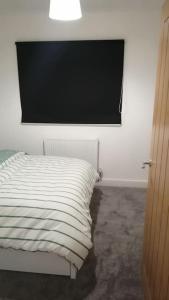 a bedroom with a bed and a flat screen tv at Lovely 1-Bedroom Flat in Hinckley, LE10 in Hinckley