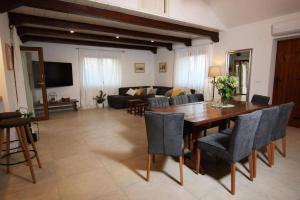 a living room with a table and chairs and a couch at Villa Amber in Supetar