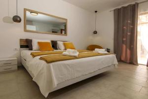 a bedroom with a large bed with two towels on it at Villa Amber in Supetar +37 photos