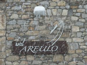 
a sign on a wall with graffiti on it at Hotel Areulo in Cerler
