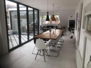 a kitchen with a large wooden table and chairs at Stunning Richmond Maisionette with rooftop patio in Richmond