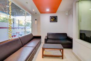a living room with a couch and a table at Treebo Trend Seven Suites in Nagpur