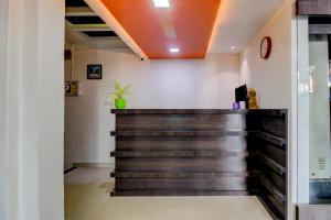 a barber shop with a wooden wall at Treebo Trend Seven Suites in Nagpur