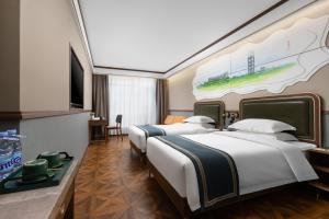 a hotel room with two beds and a tv at Nostalgia S Hotel - Olympic Sports Center in Beijing