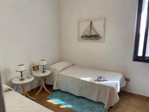 A bed or beds in a room at Apartment in Porto Pollo near Surf Paradise