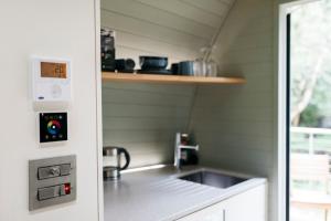 a small kitchen with a sink and a stove at RiverBeds - Luxury Wee Lodges with Hot Tubs in Glencoe +23 photos