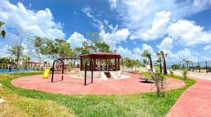 a park with a playground with a swing at Cancún Smart House with pool & AquaPark in Cancún