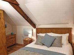 a bedroom with a bed with a wooden headboard at Galleri hot tub 2 bed ensuite in Blaencelyn +27 photos