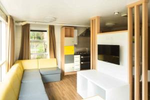a living room with a couch and a kitchen at Queens's University Elms BT9 in Belfast