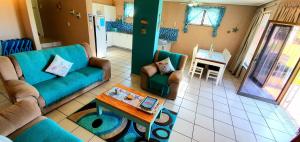 a living room with two couches and a table at Calamari 11 - 6 Sleeper - 30 Steps From The Beach! in Margate