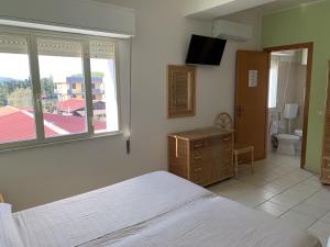 Letto o letti in una camera di Hotel Il Triangolo