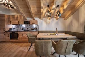 a kitchen with a wooden table and chairs at AlpenParks Premium Apartment Rehrenberg II in Viehhofen