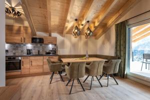 a kitchen with a dining room table and chairs at AlpenParks Premium Apartment Rehrenberg II in Viehhofen
