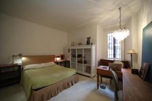 a bedroom with a bed and a desk with a laptop at Pallata 52 in Brescia