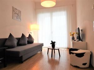 a living room with a couch and a table at Braviscasa - Ferienresidenz Stadttor Endingen in Endingen