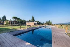 une grande piscine avec une terrasse en bois dans l'établissement Pieve Del Castello, à Deruta