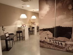 a dining room with a picture of a barn on the wall at Hello Villarreal Pension in Villareal