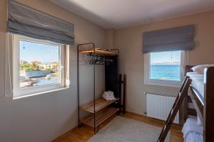 a bedroom with a bunk bed and a window with the ocean at Dream House in Áyioi