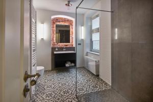 y baño con ducha, lavabo y espejo. en VIA`s Appartements und Ferienwohnungen en Görlitz