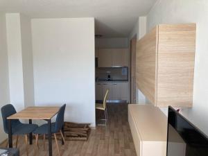 a small kitchen and dining room with a table and chairs at Apartmán Všemina 300 in Všemina