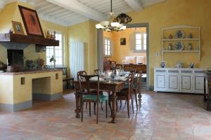 a dining room with a table with chairs and a fireplace at Villa Ginevra by Tenuta di Ghizzano in Ghizzano +38 photos