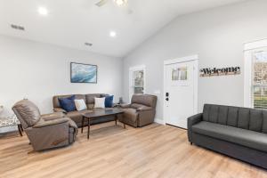 a living room with a couch and chairs and a table at Brand New Entire Home close to beach in St. Augustine