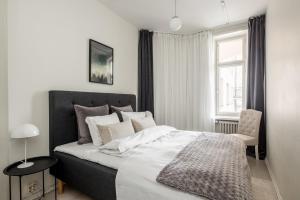 a bedroom with a large bed and a window at Comfortable city home in Helsinki