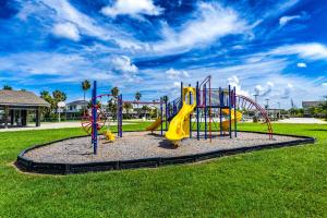 a playground with a slide in a park at Bungalow by the Bay in Galveston