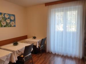 two tables in a room with a window at Haus Beim Seppl in Naturno +26 photos
