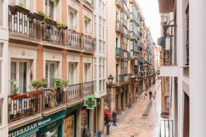a street in the city with people walking down it at Beautiful Old Town by Next Stop Bilbao in Bilbao
