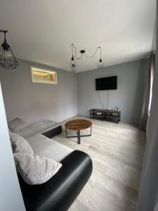 a living room with a couch and a table at Apartament24-Just in Center in Bolesławiec