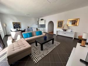 a living room with a couch and a table at Sunset Apartment in Orasac