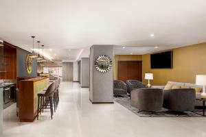 a lobby of a hotel with a bar and a living room at Empire Marquês Hotel in Lisbon
