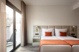 a bedroom with a bed and a large window at Empire Marquês Hotel in Lisbon