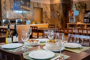 a table with wine glasses and a bowl of food at Hotel Santa Catarina Algarve in Portimão