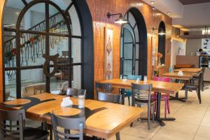 a restaurant with wooden tables and chairs at Hotel Posada Del Sol in Salta