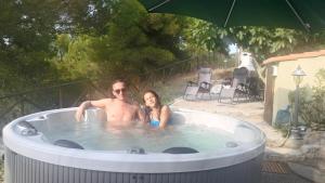 a man and a woman sitting in a hot tub at Arpaderba B&B in Livorno