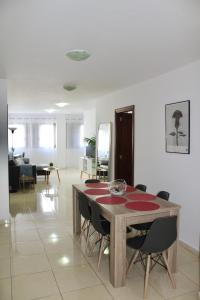 a dining table and chairs in a living room at La Guarida de Alcalán in Alcalá