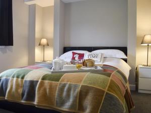 a hotel room with a bed with a tray of food on it at The Lodge at Braemor in Arrochar