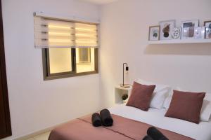 a bedroom with a bed with shoes on it at La Guarida de Alcalán in Alcalá