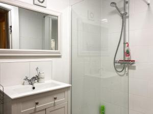 a white bathroom with a sink and a shower at The Farmers Den in Lydford