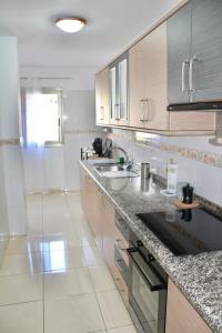 a kitchen with a sink and a counter top at La Guarida de Alcalán in Alcalá