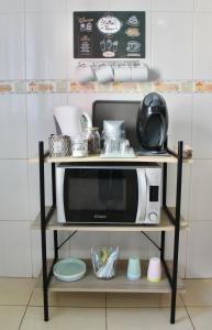 a microwave on a shelf in a kitchen at La Guarida de Alcalán in Alcalá