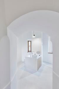 a white bathroom with a tub and a sink at Château de Sibra in Lagarde