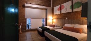 Postel nebo postele na pokoji v ubytování Botánica Casa Hotel